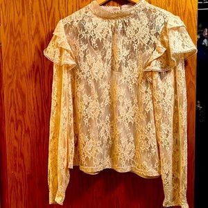 Beautiful lace long sleeve top. Buttons at neck, buttons at sleeves. Size medium